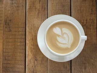 Cup of cappuccino on the table in a cafe, top view