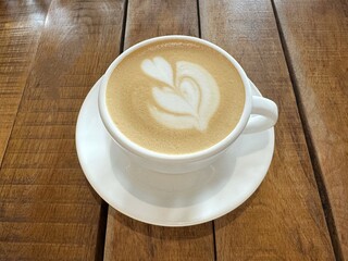 Cup of cappuccino on the table in a cafe, close up