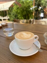 Cup of cappuccino on the table in the restaurant
