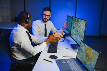 Diverse call center operators team use computers consulting clients in office