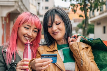 Sale, shopping, tourism and happy people concept. Beautiful females with shopping bags in the city