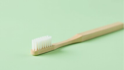 Wooden Toothbrush On Pastel Green Background