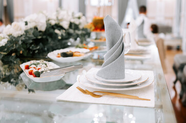 Elegant dining setup featuring stylish tableware and delicious food in a bright venue