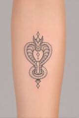 Small Black Ink Cobra Tattoo on Forearm