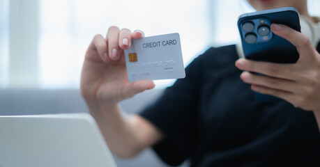 Woman holding credit card and mobile phone