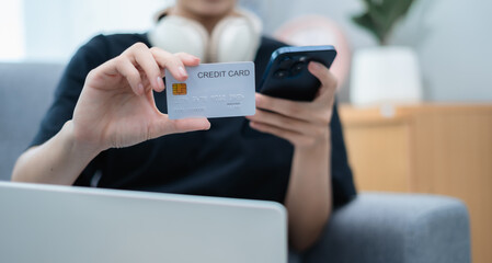 Woman holding credit card and mobile phone