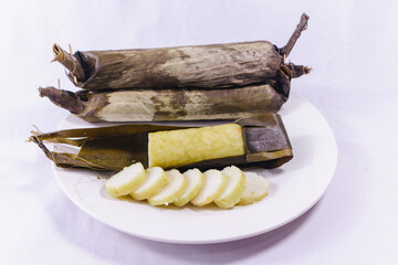 Slices of Lontong or rice cake, indonesian rice dish wrapped in banana leaves, compressed steam rice