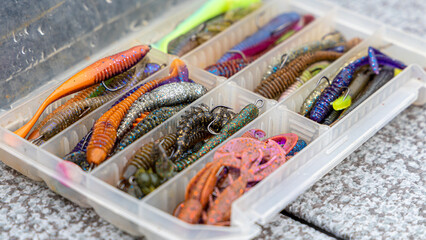 Fishing tackles and fishing baits in box .Classic Colored Fishing Lure , Beautiful Background...