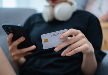 Woman holding credit card and mobile phone