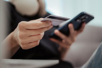 Woman holding credit card and mobile phone