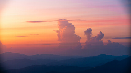 Majestic sunset over mountain range with dramatic cloudscape