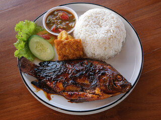 Ikan nila bakar or grilled tilapia. Grilled tilapia with sweet soy sauce