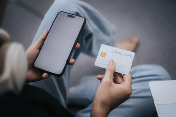 Woman holding credit card and mobile phone