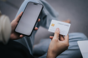 Woman holding credit card and mobile phone