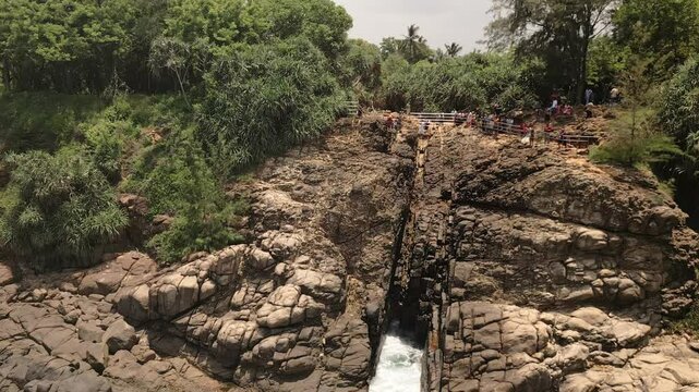 Aerial view Hummanaya Blowhole on southern coast of Sri Lanka, showcasing powerful ocean spray erupting through coastal rock cliffs near Kudawella village. Famous travel destination in Srilanka