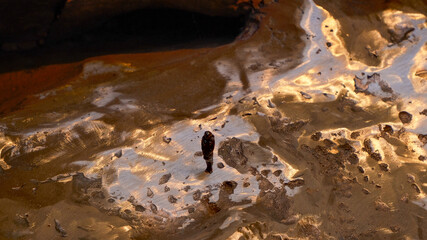 Tiny Bronze Figure on Abstract Metallic Surface – Artistic Close-Up Highlighting Texture, Light Reflection and Solitary Human Form in Sculpted Landscape for Conceptual Art and Photography Enthusiasts