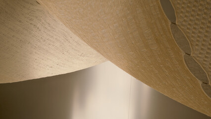 Elegant close-up of woven textile structures in natural light—minimalist abstract photo highlighting textures, patterns, and shadows in a soft neutral tone for design inspiration and artistic mood