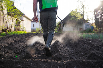 Farmer spraying fertilizer.  Pest control and plant diseases to obtain a large harvest