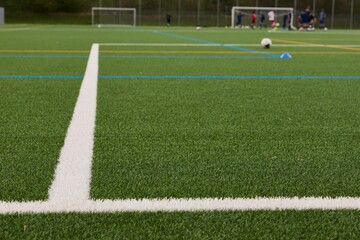 Close-up of a soccer field with white lines.