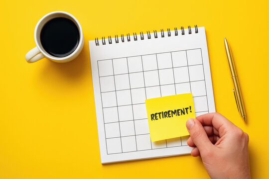 A person marks "Retirement!" on a calendar next to a coffee and pen, symbolizing the planning of retirement on a bright yellow background.