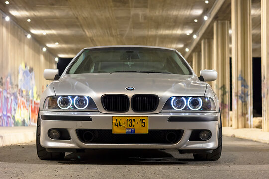 Rishon Lezion, Israel 22.08.2024. BMW M5 E39 parked on the street on a warm summer day against a wall with graffiti in the background.