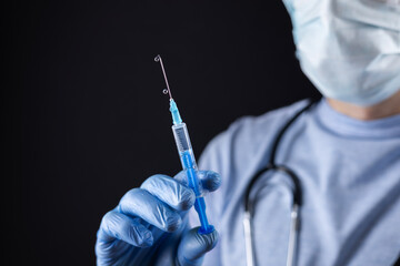 Doctor in gloves hold syringe with medication, closeup. Vaccination and immunization