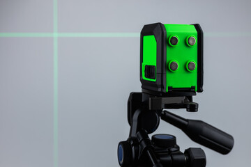 Laser level meter green light measuring in construction site for interior decoration