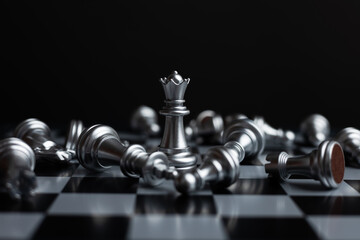 silver queen chess surrounded by a number of fallen silver chess pieces, business strategy concept