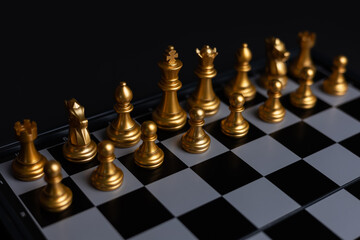 The set of golden chess pieces element, king, queen rook, bishop, knight, pawn standing on...