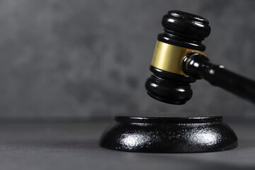 Black judges gavel on the table on a dark background