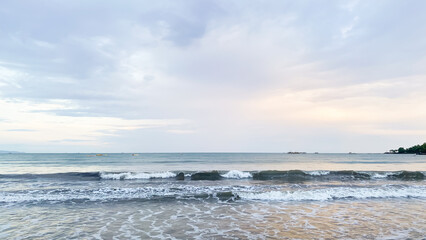 A calm sea view with gentle waves and sunset, perfect for a peaceful nature, weather and beach theme.