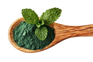 Green powder in wooden spoon with fresh mint