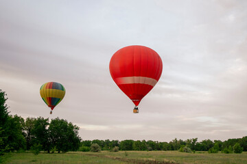 A vibrant aerostat balloon takes off and ascends into the sky