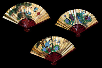 Three traditional Japanese folding hand fans on black background