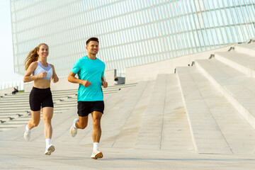 Morning joggers enjoying fitness and fresh air at a modern urban park with sleek architecture