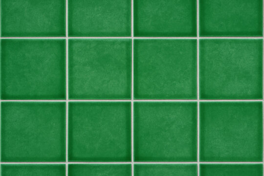 Green Tile Grid: A close-up, symmetrical view of a grid of vibrant, green tiles, arranged in neat rows and columns with bright white grout, creating a sense of order and cleanliness.