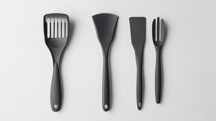Fototapeta premium A set of sleek, modern kitchen utensils isolated, including a basting brush, salad tong, and pastry brush, all designed with ergonomic handles