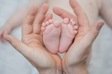 Tiny Feet in Gentle Hands: A tender moment captured as a parent cradles the delicate feet of a newborn, a symbol of love, care, and new beginnings.