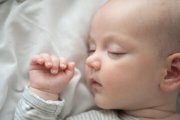 Dreamy Slumber: A peaceful portrait of a serene baby, fast asleep on a soft bed, embodying the innocence and tranquility of childhood.