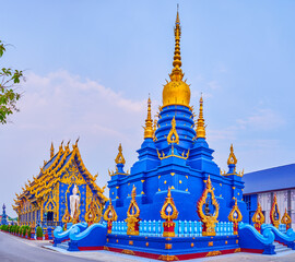Naklejka premium Chedi of Wat Rong Suea Ten in blue color with golden elements, Chiang Rai, Thailan