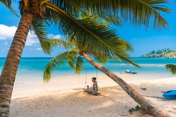 Travel people enjoy summer vacation on beautiful tropical beach with scenery palm tree and crystal clear ocean