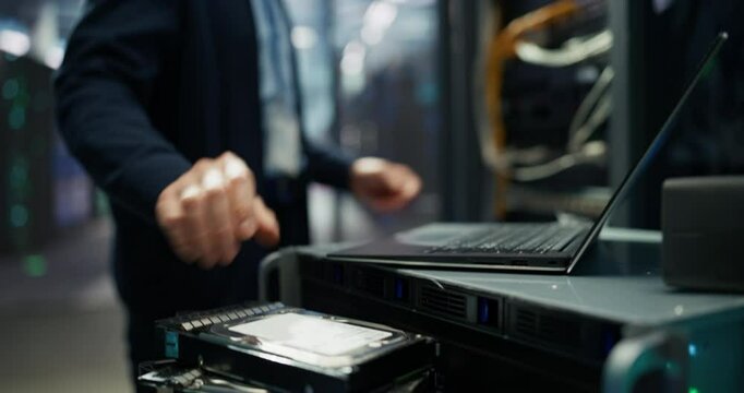 Asian IT Technician Working with Server Racks in a Modern Data Center. Providing Maintenance Work and Installing New Hardware for Database and Storage Hard Drives for AI Model Training and Compute