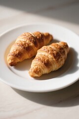 there are two croissants on a plate on a table