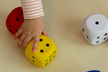 the child takes the dice