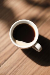 Fototapeta premium there is a cup of coffee on a wooden table