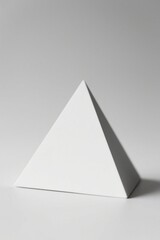 there is a white pyramid with a small white object in it