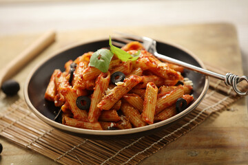 Pasta with simple tomato sauce with black olive 