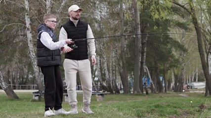 Father and son spend Father's Day fishing. Dad sets an example for his child on how to spend time usefully.