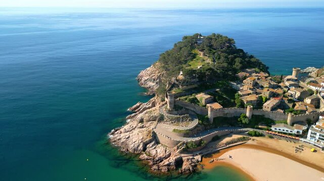 Breathtaking aerial view of tossa de mar, a charming coastal town nestled on the costa brava in catalonia, spain, showcasing its beautiful beach, historic castle, and whitewashed buildings
