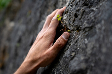 Close-Up Of Healthy Finger Grip In Rock Climbing: Climber’s Hand Maintaining Safe Hanging Position On Textured Limestone Surface During Outdoor Ascent In Bavaria, Germany